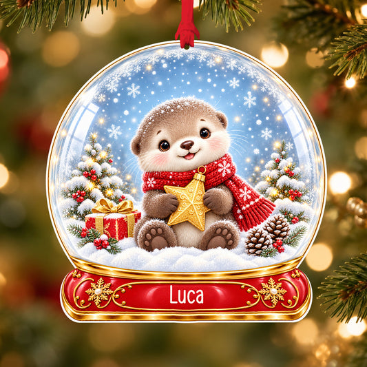 Personalised Christmas otter acrylic snow globe Christmas bauble with custom name, hanging on a Christmas tree with red ribbon