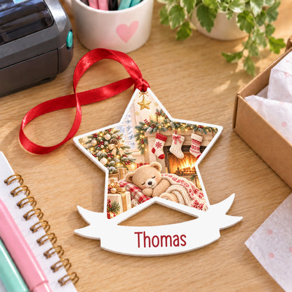 Personalised cosy Christmas fireplace white acrylic star bauble with name, 10cm Christmas decoration with ribbon, shown on a desk
