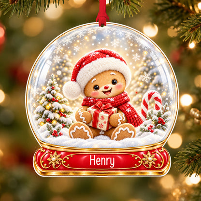 Personalised gingerbread boy acrylic snow globe Christmas bauble with custom name, hanging on a Christmas tree with red ribbon