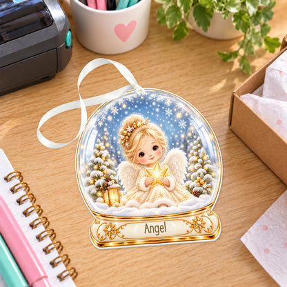 Personalised gold Christmas angel snow globe bauble with name, white acrylic Christmas decoration with ribbon, shown on a desk