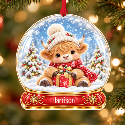 Personalised Highland calf acrylic snow globe Christmas bauble with custom name, hanging on a Christmas tree with red ribbon
