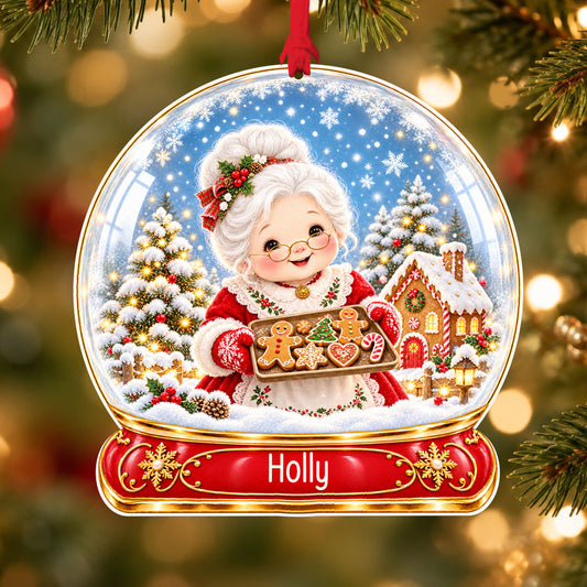 Personalised Mrs Claus baking acrylic snow globe Christmas bauble with custom name, hanging on a Christmas tree with red ribbon