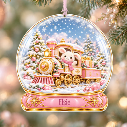 Personalised pink Christmas train acrylic snow globe Christmas bauble with custom name, hanging on a Christmas tree with baby pink ribbon