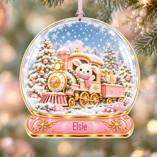 Personalised pink Christmas train acrylic snow globe Christmas bauble with custom name, hanging on a Christmas tree with baby pink ribbon