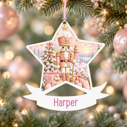 Personalised pink nutcracker acrylic star Christmas bauble with custom name, hanging on a Christmas tree with baby pink ribbon