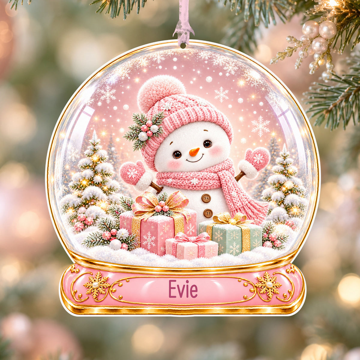 Personalised pink snowman acrylic snow globe Christmas bauble with custom name, hanging on a Christmas tree with baby pink ribbon