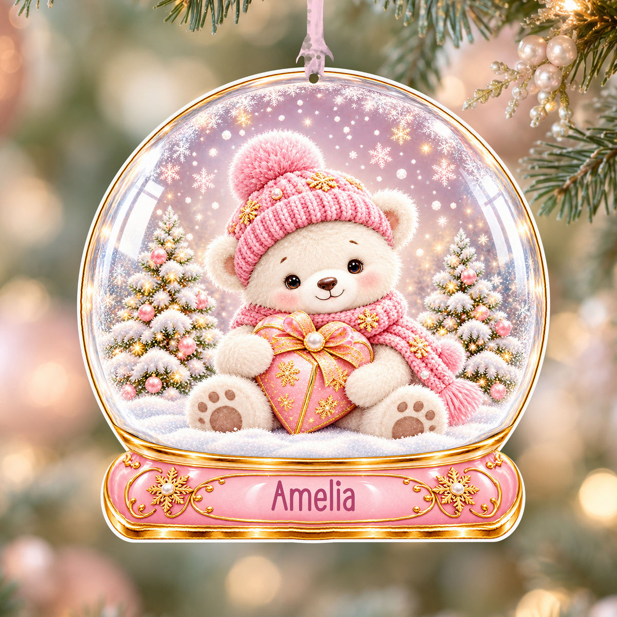 Personalised pink teddy acrylic snow globe Christmas bauble with custom name, hanging on a Christmas tree with baby pink ribbon
