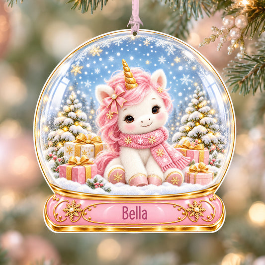 Personalised pink unicorn acrylic snow globe Christmas bauble with custom name, hanging on a Christmas tree with baby pink ribbon