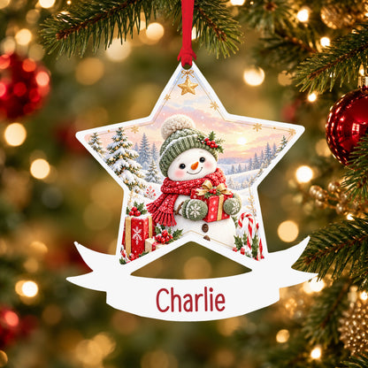 Personalised red and green snowman acrylic star Christmas bauble with custom name, hanging on a Christmas tree with red ribbon