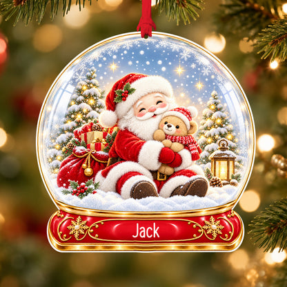 Personalised Santa and teddy acrylic snow globe Christmas bauble with custom name, hanging on a Christmas tree with red ribbon