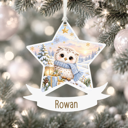 Personalised snowy baby owl acrylic star Christmas bauble with custom name, hanging on a Christmas tree with white ribbon