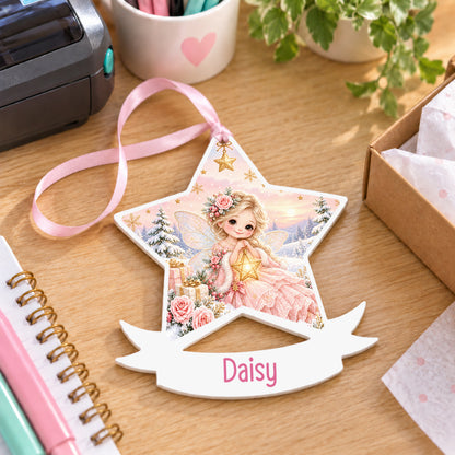 Personalised winter fairy white acrylic star bauble with name, 10cm Christmas decoration with ribbon, shown on a desk