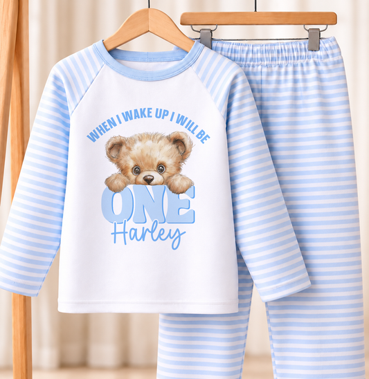 Personalised blue and white striped kids birthday pyjamas with When I Wake Up Peeking Teddy design, name and age printed on the front