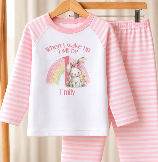 Personalised pink and white striped kids birthday pyjamas with When I Wake Up I Will Be rainbow bunny design, name and age printed on the front