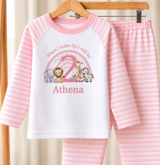Personalised pink and white striped kids birthday pyjamas with When I Wake Up I Will Be safari rainbow design, name and age printed on the front