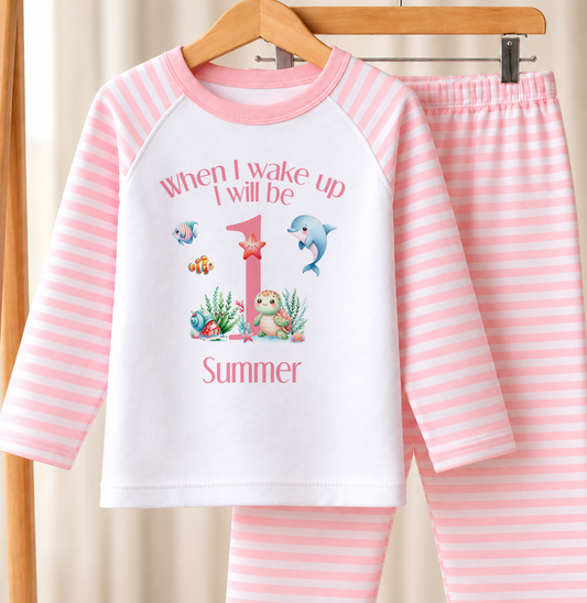 Personalised pink and white striped kids birthday pyjamas with When I Wake Up I Will Be under the sea design, name and age printed on the front