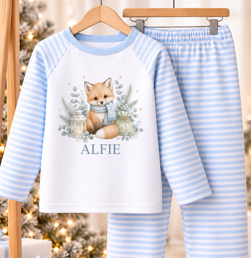 Personalised blue and white striped kids Christmas pyjamas with Winter Fox design and a custom name printed on the front