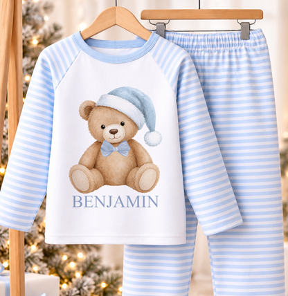 Personalised blue and white striped kids Christmas pyjamas with Blue Hat Teddy design and a custom name printed on the front