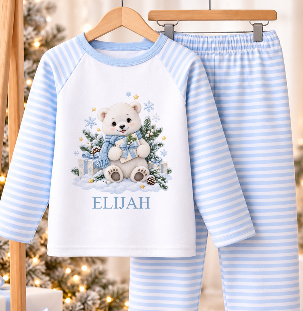 Personalised blue and white striped kids Christmas pyjamas with Polar Bear with Present design and a custom name printed on the front