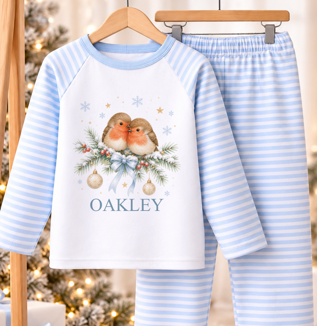 Personalised blue and white striped kids Christmas pyjamas with Two Robins design and a custom name printed on the front