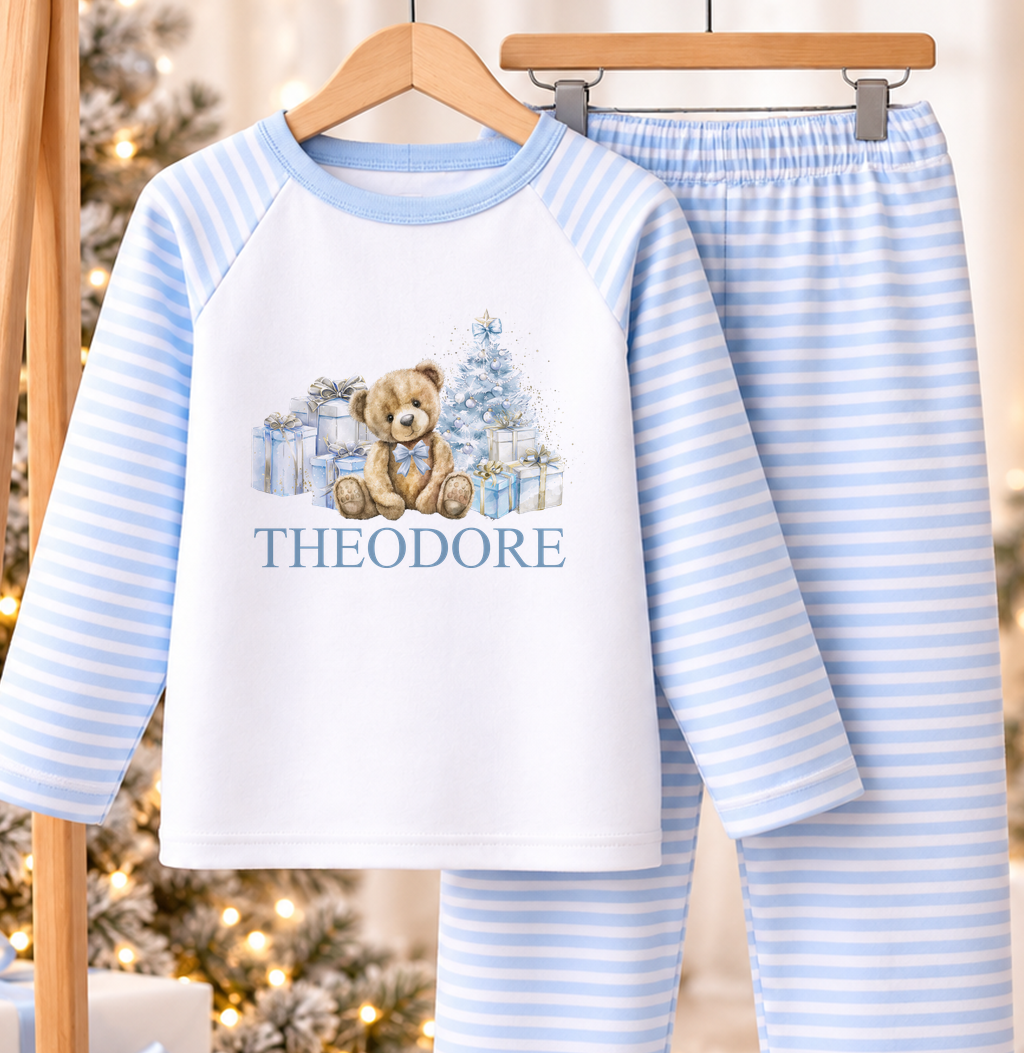 Personalised blue and white striped kids Christmas pyjamas with Blue Teddy and Presents design and a custom name printed on the front