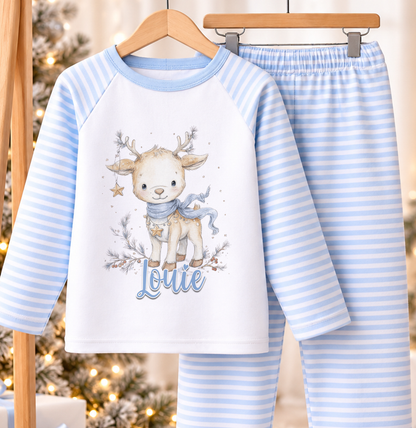 Personalised blue and white striped kids Christmas pyjamas with Winter Reindeer design and a custom name printed on the front