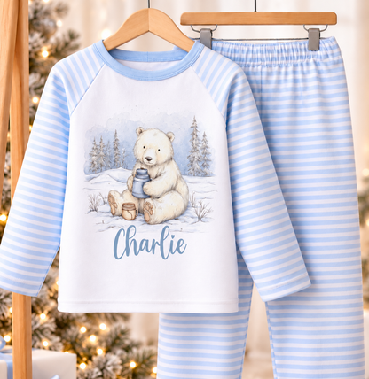 Snowy Polar Bear personalised blue striped Christmas pyjamas hanging by the Christmas tree