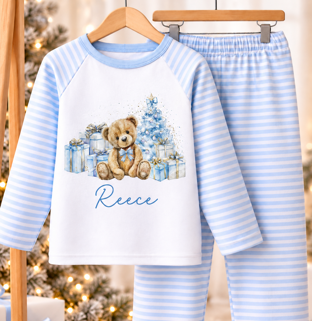 Blue Teddy and Presents personalised blue striped Christmas pyjamas hanging by the Christmas tree