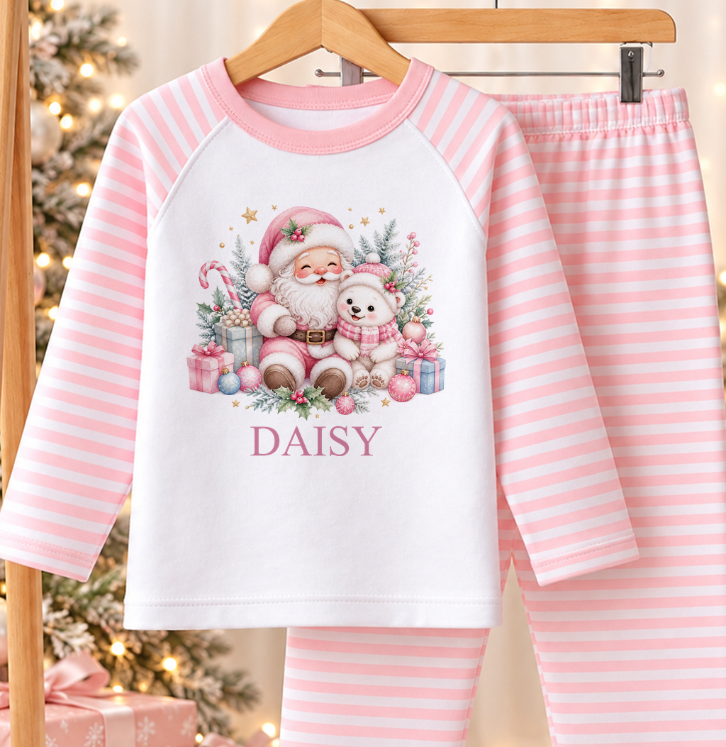 Personalised pink and white striped kids Christmas pyjamas with Pink Santa and Polar Bear design and a custom name printed on the front