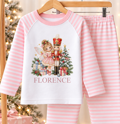 Personalised pink and white striped kids Christmas pyjamas with Fairy and Nutcracker design and a custom name printed on the front