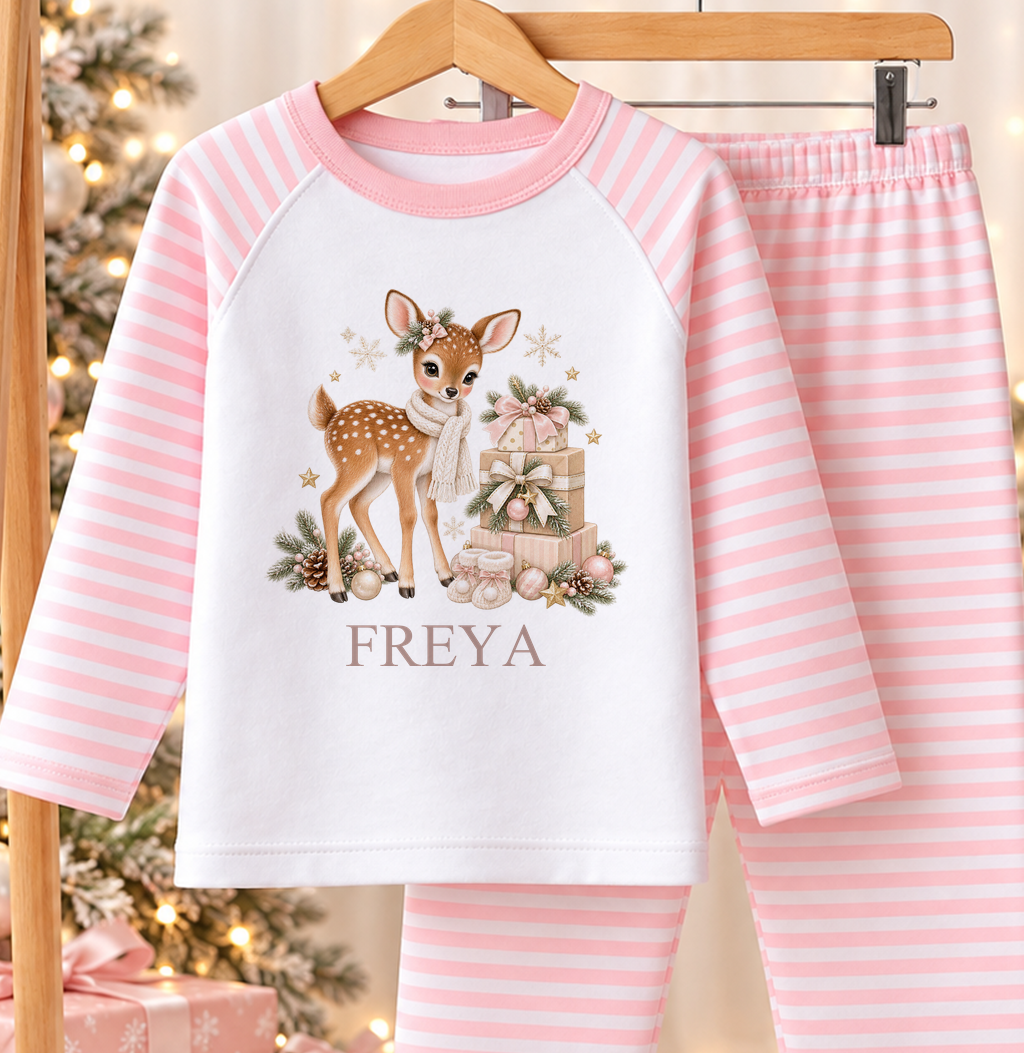 Personalised pink and white striped kids Christmas pyjamas with Fawn and Gift Stack design and a custom name printed on the front