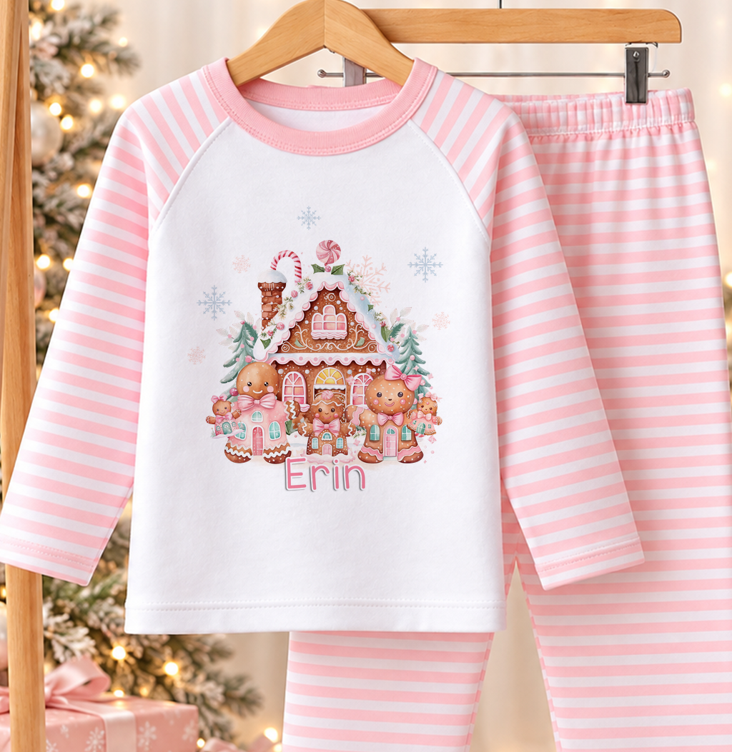 Personalised pink and white striped kids Christmas pyjamas with Gingerbread House design and a custom name printed on the front