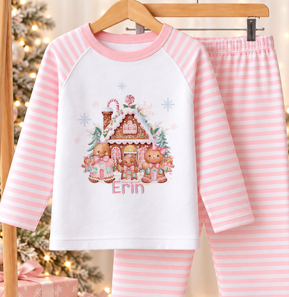 Personalised pink and white striped kids Christmas pyjamas with Gingerbread House design and a custom name printed on the front