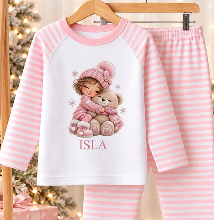 Personalised pink and white striped kids Christmas pyjamas with Girl Hugging Teddy design and a custom name printed on the front
