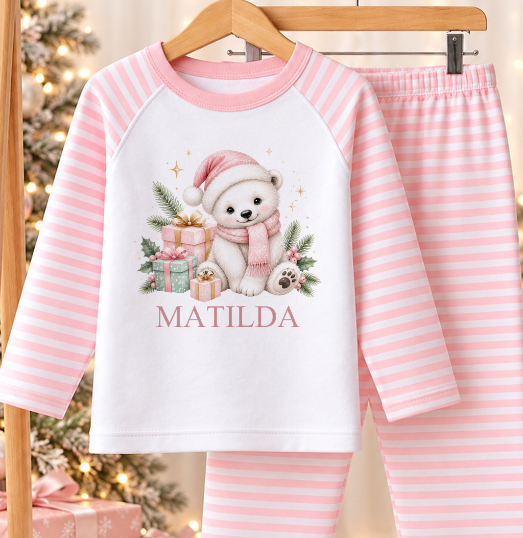 Personalised pink and white striped kids Christmas pyjamas with Polar Bear Cub Santa Hat design and a custom name printed on the front