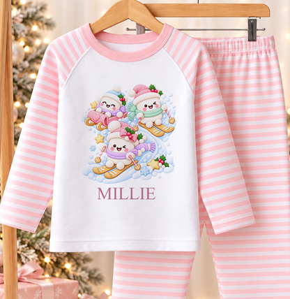 Personalised pink and white striped kids Christmas pyjamas with Snowman Ski Day design and a custom name printed on the front