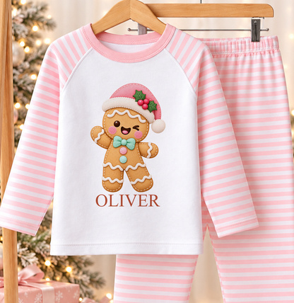 Personalised pink and white striped kids Christmas pyjamas with Gingerbread Santa Hat design and a custom name printed on the front