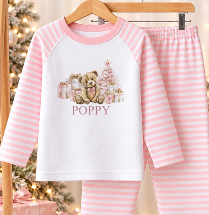 Personalised pink and white striped kids Christmas pyjamas with Teddy and Presents design – name example in classic lettering