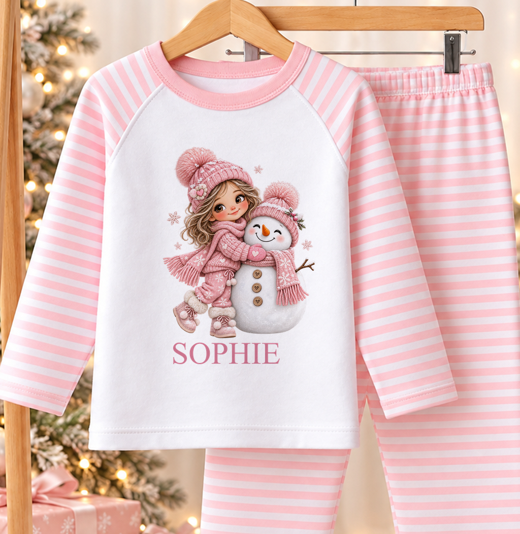 Personalised pink and white striped kids Christmas pyjamas with Brunette Girl and Snowman design and a custom name printed on the front