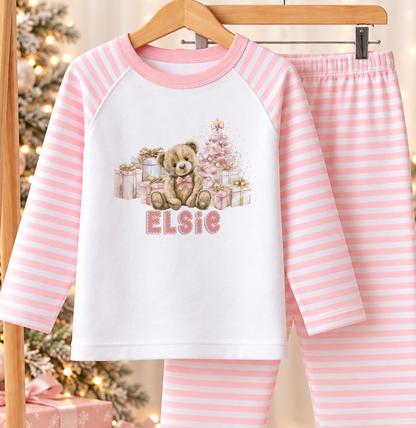Personalised pink and white striped kids Christmas pyjamas with Teddy and Presents design and a custom name printed on the front