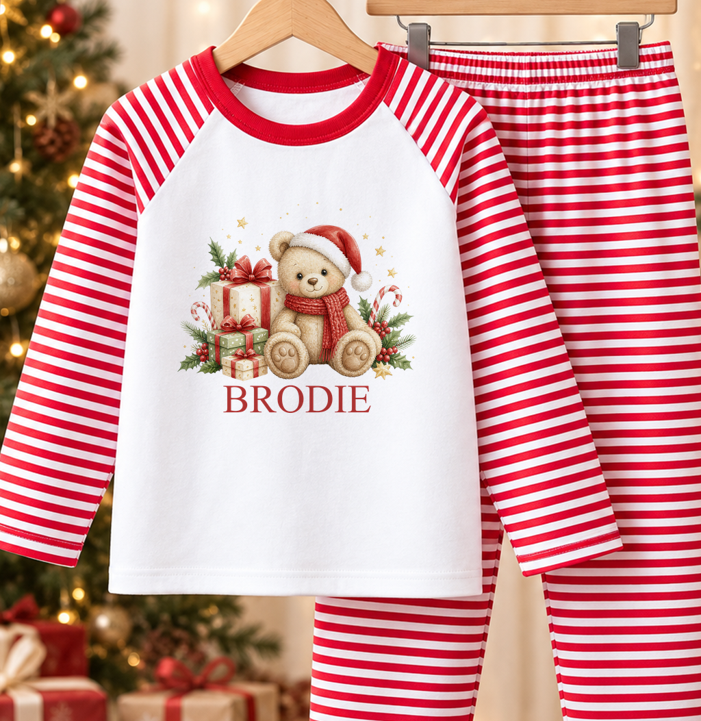 Personalised red and white striped kids Christmas pyjamas with Cosy Scarf Teddy design and a custom name printed on the front