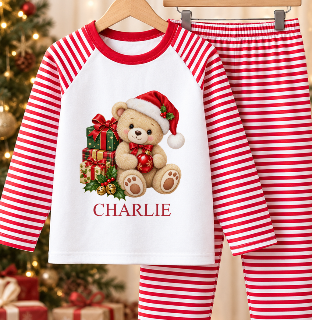 Personalised red and white striped kids Christmas pyjamas with Teddy with Presents design and a custom name printed on the front