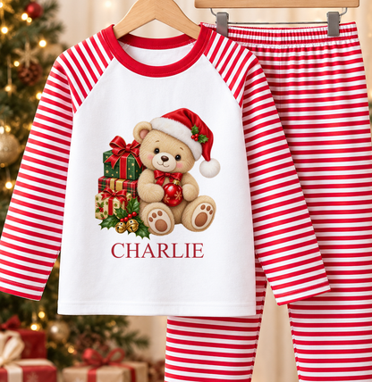Personalised red and white striped kids Christmas pyjamas with Teddy with Presents design and a custom name printed on the front