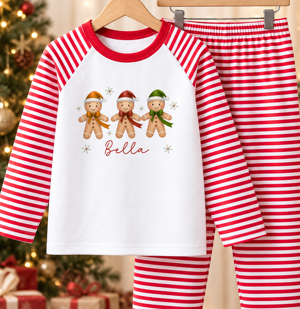 Personalised red and white striped kids Christmas pyjamas with Gingerbread Trio design and a custom name printed on the front