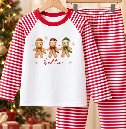 Personalised red and white striped kids Christmas pyjamas with Gingerbread Trio design and a custom name printed on the front