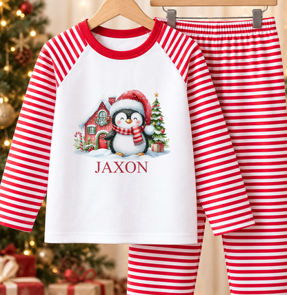 Personalised red and white striped kids Christmas pyjamas with Santa Hat Penguin design and a custom name printed on the front