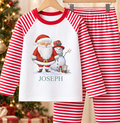 Personalised red and white striped kids Christmas pyjamas with Santa and Snowman design and a custom name printed on the front