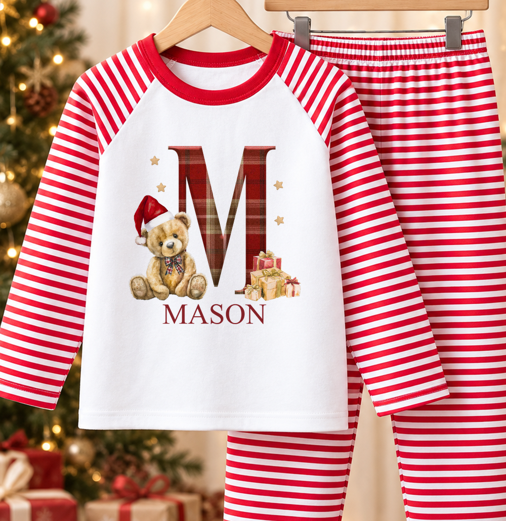 Personalised red and white striped kids Christmas pyjamas with Tartan Initial Teddy design and a custom name printed on the front