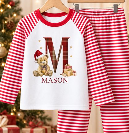 Personalised red and white striped kids Christmas pyjamas with Tartan Initial Teddy design and a custom name printed on the front