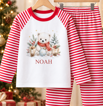Personalised red and white striped kids Christmas pyjamas with Polar Bear in Red Scarf design and a custom name printed on the front